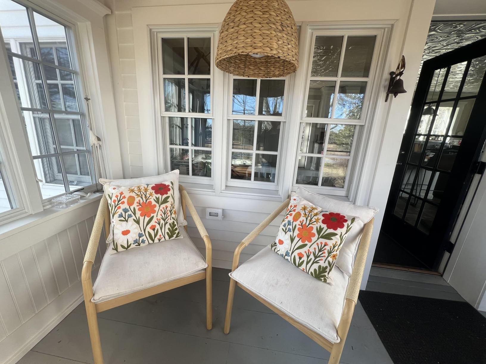 Embroidered pillow cover on a customer accent chair